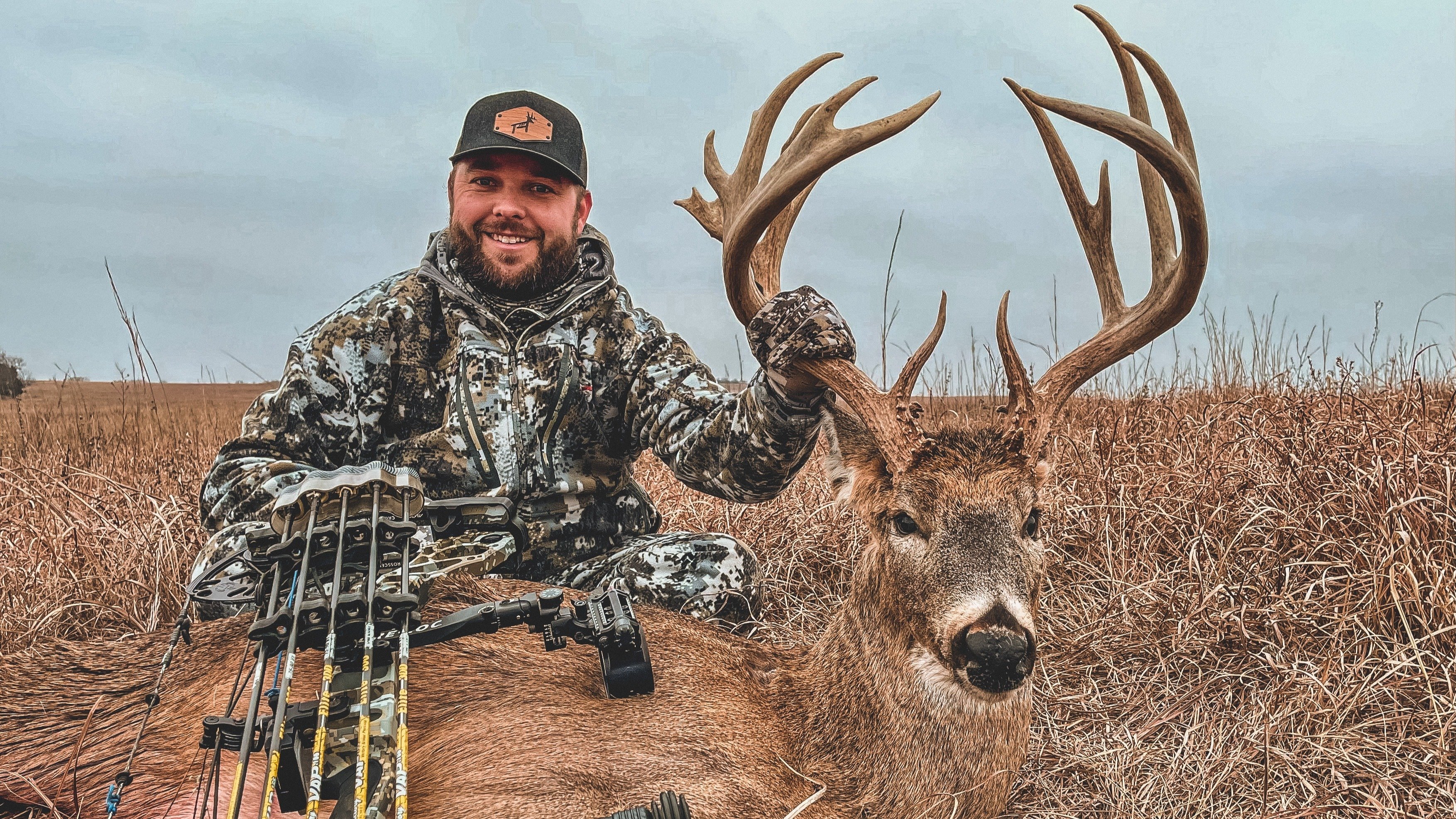 Redmond field expert Isaac Boon sits beside his harvested whitetail buck.