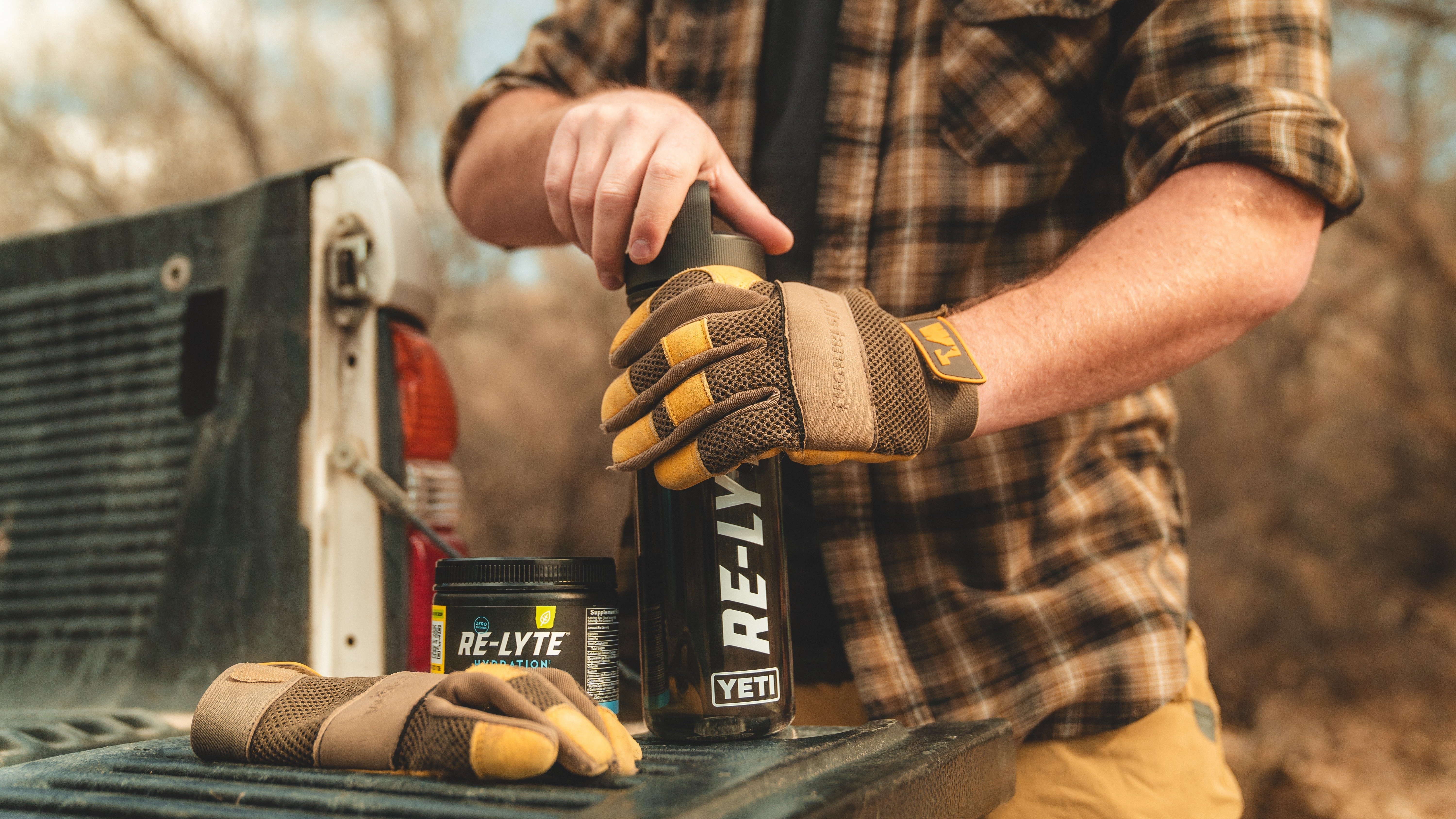 A man oudoors holds a Yeti bottle filled with Redmond Re-Lyte Hydration—a clean electrolyte mix for people.